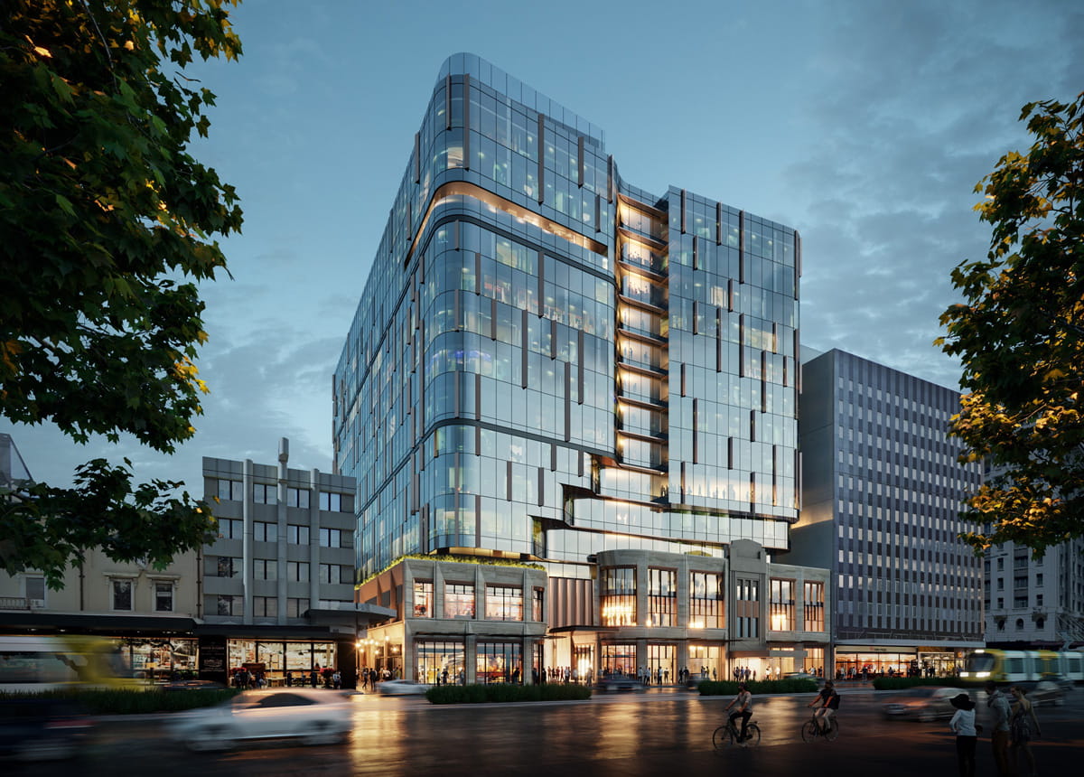 A large modern glass office building at sunset