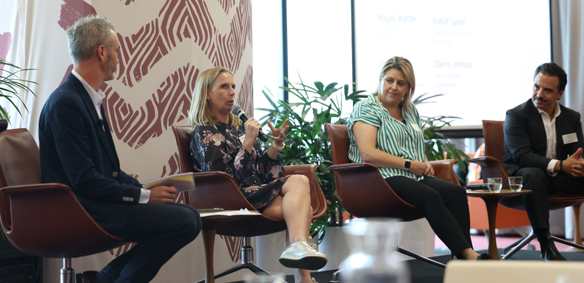 Magali Wardle sits in a chair with a microphone with people either side of her as she speaks at a Data Centres Forum at GBCA TRANSFORM 2026