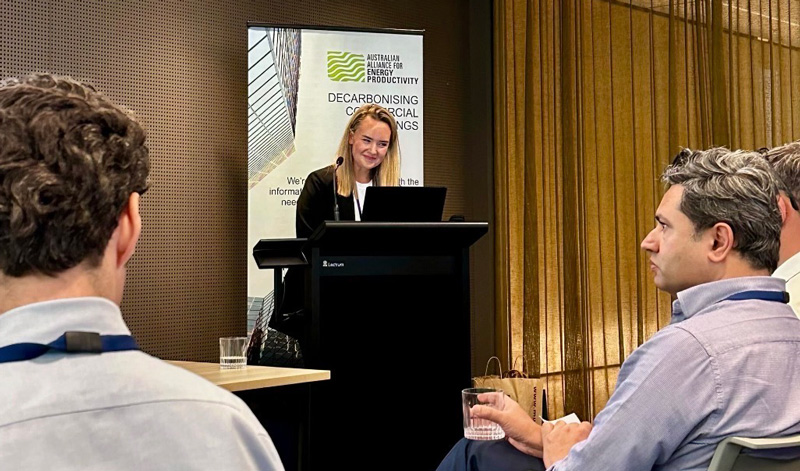 Matilde Martin standing on the podium delivering her speech on NABERS energy updates