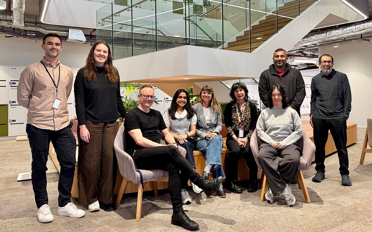 6 members of the NABERS product development team sitting and standing and smiling